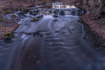 waterfall in several stages and fallen leaves