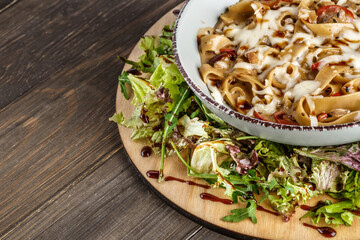 Pasta bolognese. Traditional italian dish of pasta with tomato and meat mince sauce served in a plate with parmesan cheese and thyme, top view