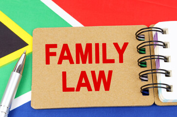 Against the background of the flag of South Africa lies a notebook with the inscription - FAMILY LAW