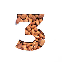 Number three made of almonds and paper cut in shape of third numeral isolated on white. Typeface of...