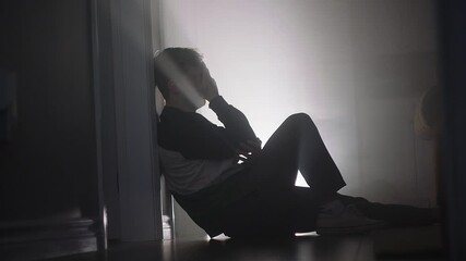 young man crying on floor