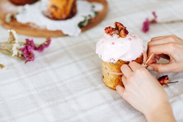 Women's hands decorate Easter. Homemade baking Easter cakes