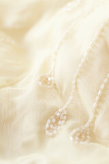 Obraz na płótnie Canvas elegant light pastel fabric with embroidery beads, aesthetic background