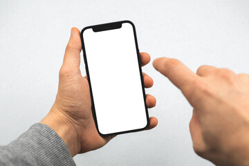 Mockup with mobile phone and man hands, person is touching white blank screen