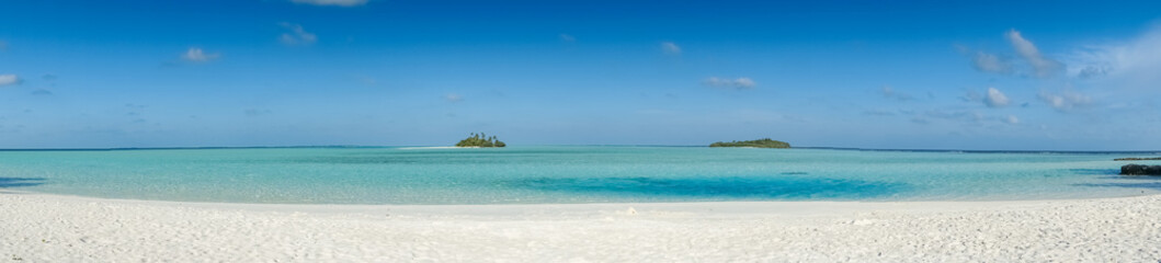 panorama of tropical beach with two isolated uninhabited islands