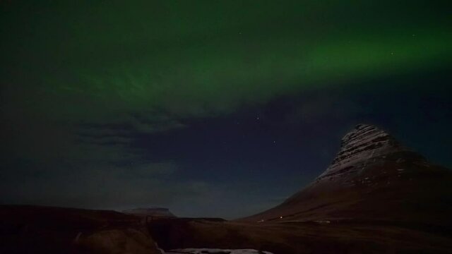 Strong Aurora Borealis over Kirkjufell Mountain in West Iceland - real time video