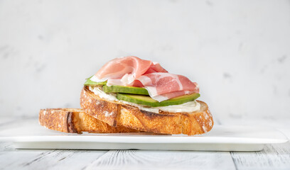 Toast with avocado, prosciutto and cream cheese
