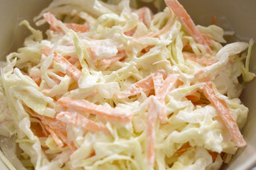 Coleslaw with cabbage and carrot in a bowl.  Healthy and dietary food concept.