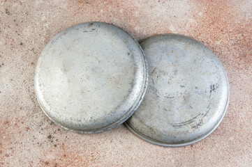 Old metal plates for scales on concrete background.