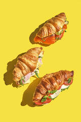 croissant sandwich with salmon, ham and cheese