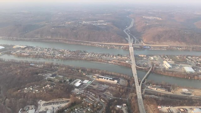An aerial flyover view of Neville Island on the Ohio River near Pittsburgh, Pennsylvania in late winter. Interstate 79 below.	