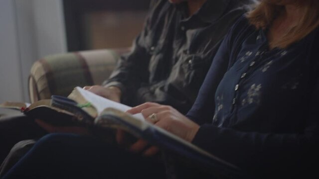 Married couple studying God's word together after church. Through bible study