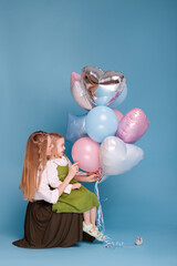 mother and daughter with balloons on a blue background. Mother's Day