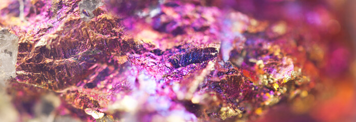 Bornite, colorful background, metal nugget. Texture minerals. Beautiful natural color pink-purple background. Extreme closeup, beautiful jewel background. Small focus size. Macro