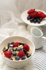 Oatmeal Porridge With Fresh Berries, Oats With Blueberry And Raspberry on white background.Rustic food photographhy.