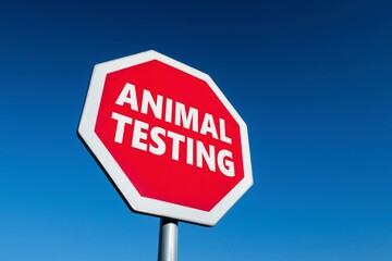 Stop traffic sign with ANIMAL TESTING text against suffering of animals during the development of cosmetics, drugs