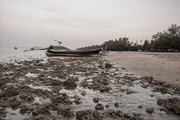 small fishing boat on the beach in the evening