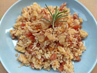 Fried rice with Chinese sausage and fermented pork served in blue plate, Thai food. Selective focus.