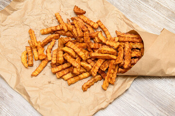 French fries on a paper bag. Fastwood. Fried French fries.