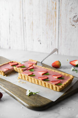 Strawberry Cheese tart on white cafe table background.
