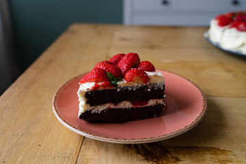 A Slice of Strawberry Raspberry Chocolate Birthday Cake with White Cream Frosting