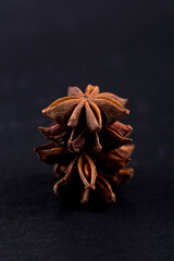 Close-up of star anise tower on black background