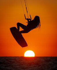Kitesurfing, silhouette of Rastafarian surfer at sunset on the sea, Israel March 10, 2021