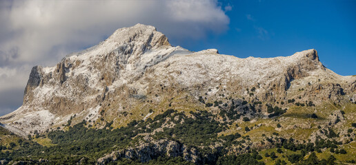mountains with snow  and clouds in the tramuntana area on the balearic island of mallorca, spain