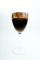 Cola in glass with ice on white background