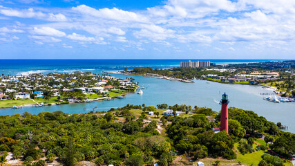 Jupiter is a town on the southeastern coast of Florida. On a hill overlooking the Loxahatchee River, the red 1860 Jupiter Inlet Lighthouse offers panoramic views. The site also has a preserved pioneer - obrazy, fototapety, plakaty