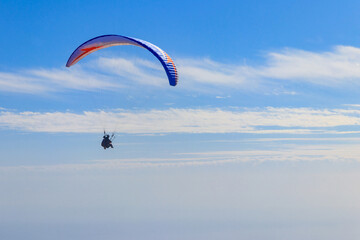 Paragliders in blue sky. Concept of active lifestyle and extreme sport adventure