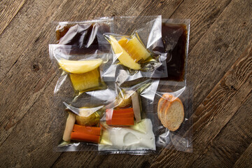 Different products and sauces in vacuum sealed plastic packaging