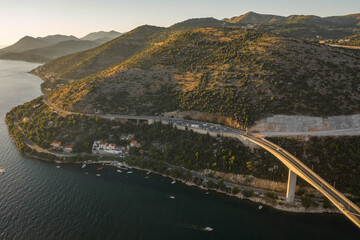 Aerial drone shot of Dubrovnik bridge west part connecting highway in Croatia summer sunset