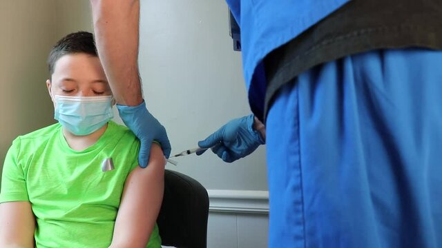 Nurse giving child a vaccine. Young man recieving medical treatment.