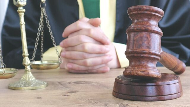 Woman lawyer working with contract papers and wooden gavel on tabel in courtroom. justice and law ,attorney, court judge, concept.
