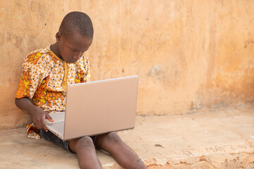 african kid using a laptop computer
