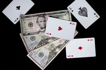 Poker and money. Composition from cards. Money games. Card games. Dollars on black background