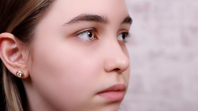 profile of a young girl, model with big eyes, macro