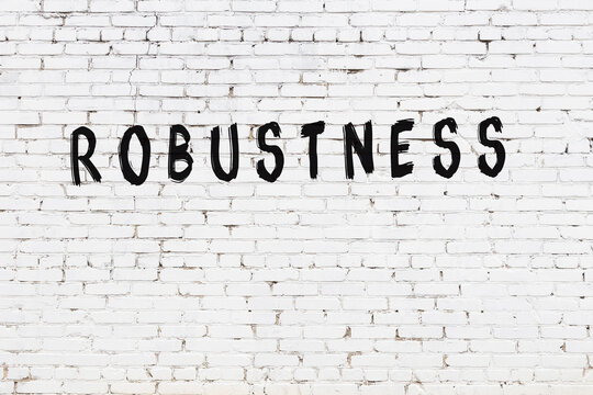 White wall with black paint inscription robustness on it