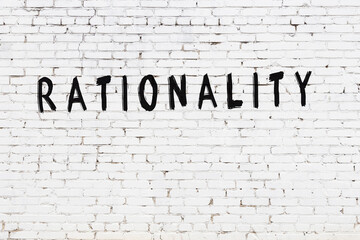 Inscription rationality painted on white brick wall