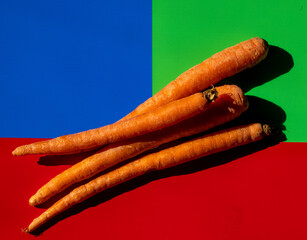 Carrots on green, blue, red background