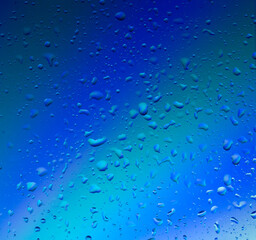 Background. Water drops on glass. Northern lights blue. High quality photo