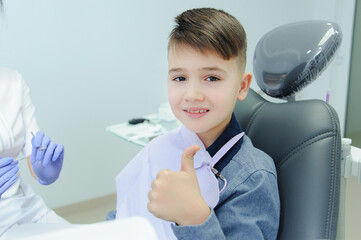 A child boy with a dentist in a dental office