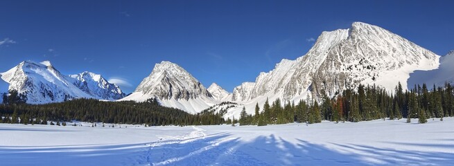 Snow Covered Alpine Meadow and Distant Mountain Peaks on Horizon.  Wide Panoramic Landscape of...