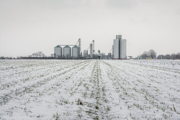 Grain silos in the farm field in winter