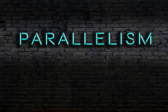 Neon sign. Word parallelism against brick wall. Night view
