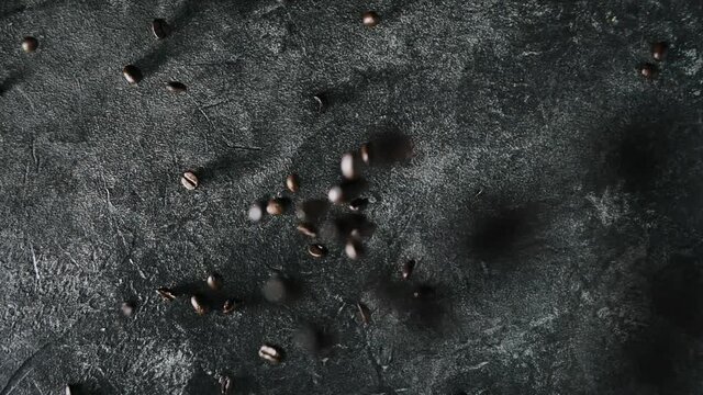roasted coffee beans(grains) poured scattered on grey table. Close up 4k.
Concept coffee making, barista, cafe promo