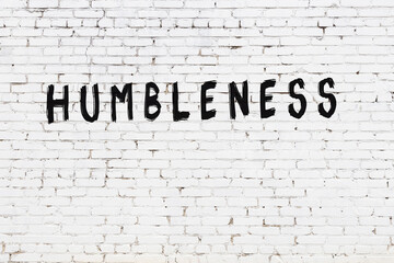 Inscription humbleness painted on white brick wall - obrazy, fototapety, plakaty