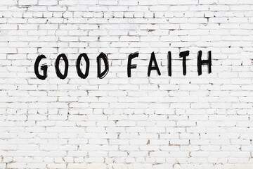 Inscription good faith painted on white brick wall