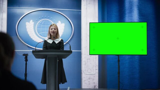 Young Girl Activist Delivering an Emotional and Scatching Speech at Press Conference in Government Building with Green Screen Mock Up on Display. Child Speaking to Congress at Summit Meeting.